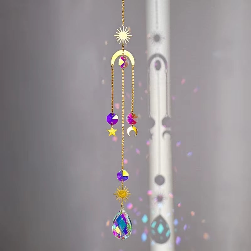 Decorative crystal suncatcher with moons and stars on a gold chain, ideal for outdoors