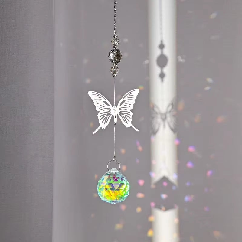 Crystal suncatcher with white butterfly design and rainbow prism ball for outdoor decor