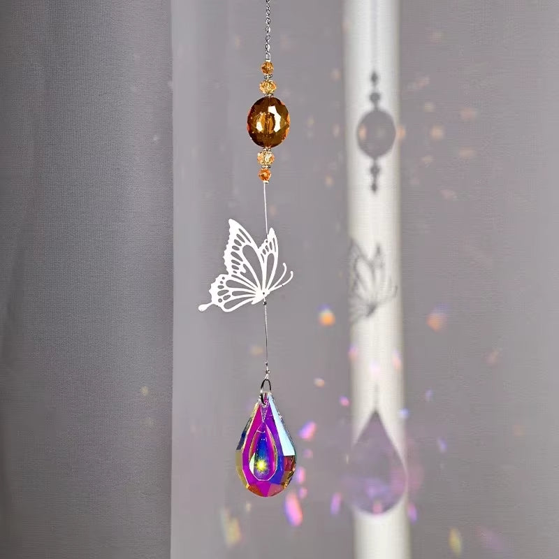 Hanging crystal suncatcher with white butterfly design and colorful teardrop pendant