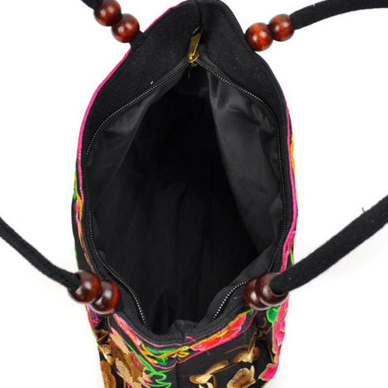 Doppelseitig bestickte Handtasche aus Baumwoll-Canvas mit Wohlstandssymbolen