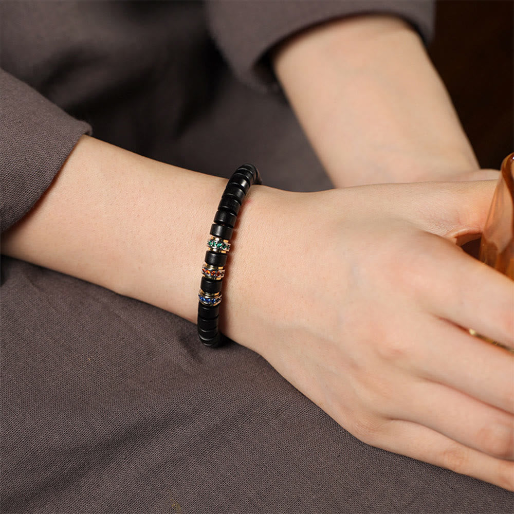 Peace-Armband aus Ebenholz mit kleinem Blatt aus rotem Sandelholz und Zirkon, Unisex