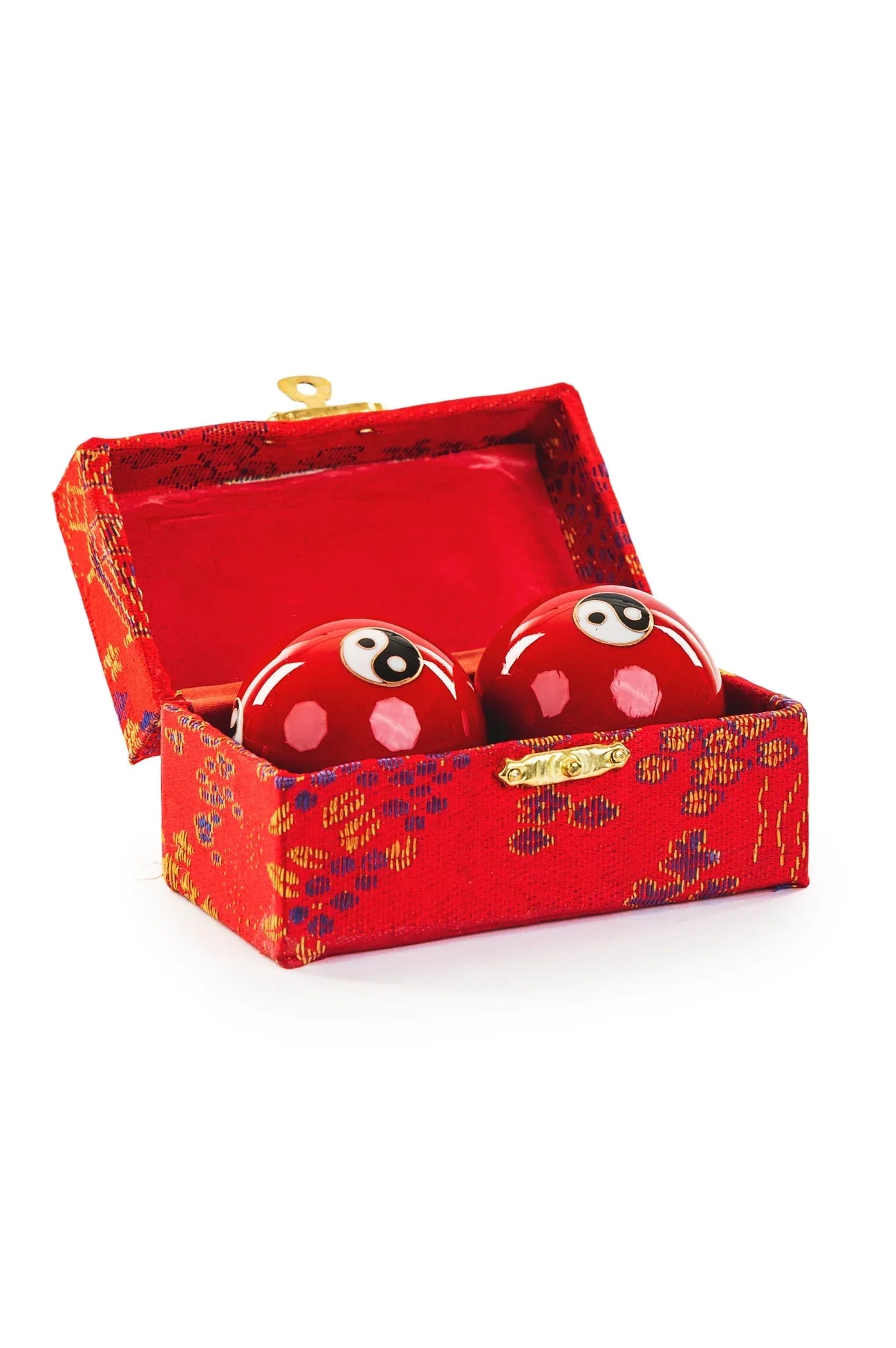 Red Chinese Baoding balls with yin-yang designs in silk box for relaxation and mindfulness