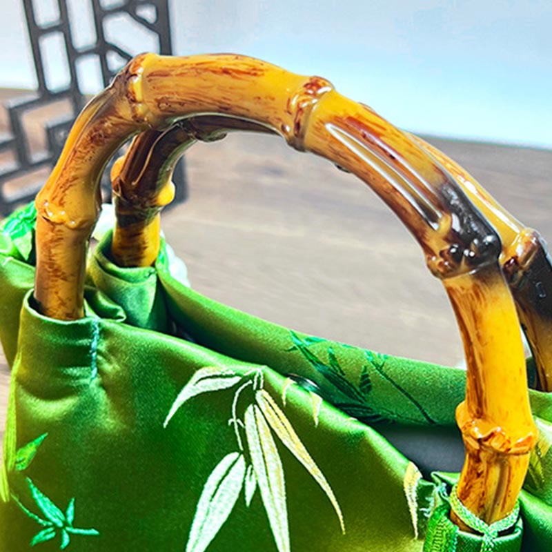 Grüne Umhängetasche mit Perlengriff und Blattstickerei