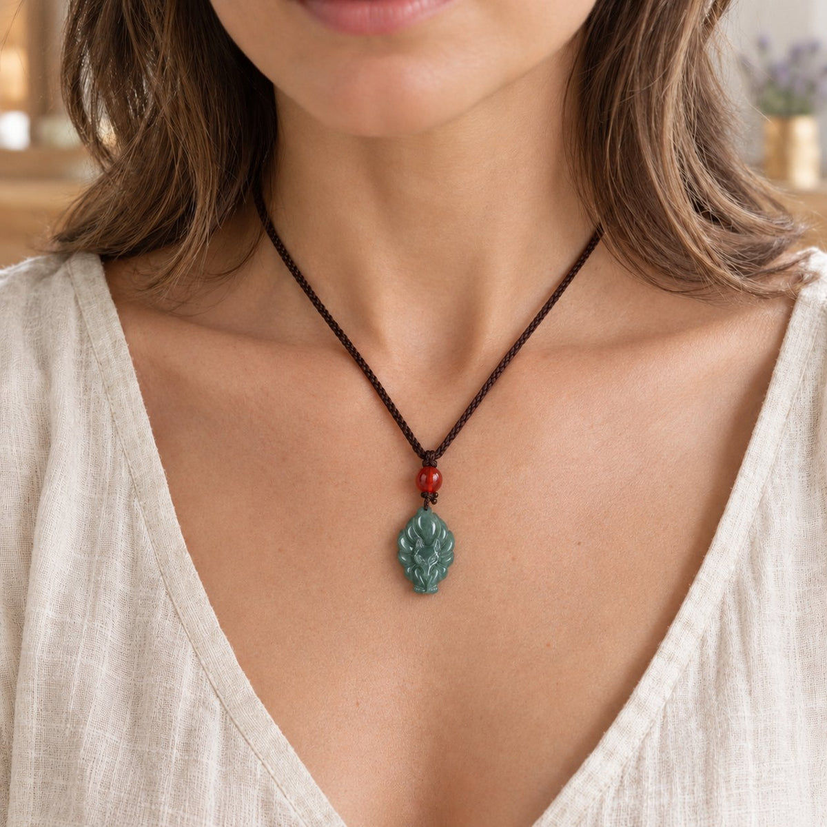 Green Jade Nine Tailed Fox Luck Necklace Pendant, worn on the neck by a woman