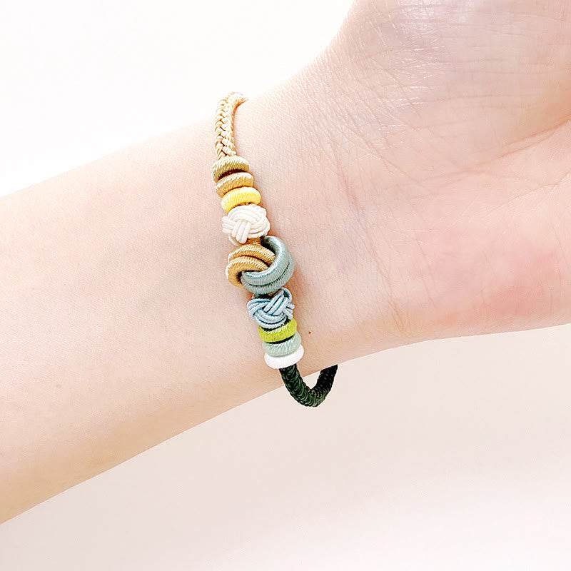 Handgefertigtes zweifarbiges Peace Knot-Armband aus roter Schnur