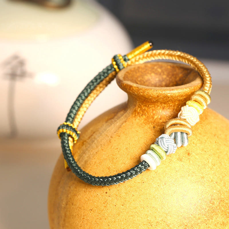 Handgefertigtes zweifarbiges Peace Knot-Armband aus roter Schnur
