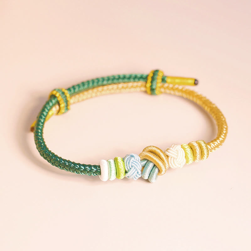 Handgefertigtes zweifarbiges Peace Knot-Armband aus roter Schnur