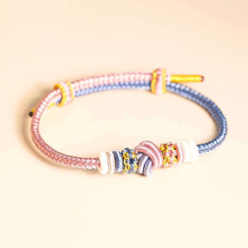 Handgefertigtes zweifarbiges Peace Knot-Armband aus roter Schnur