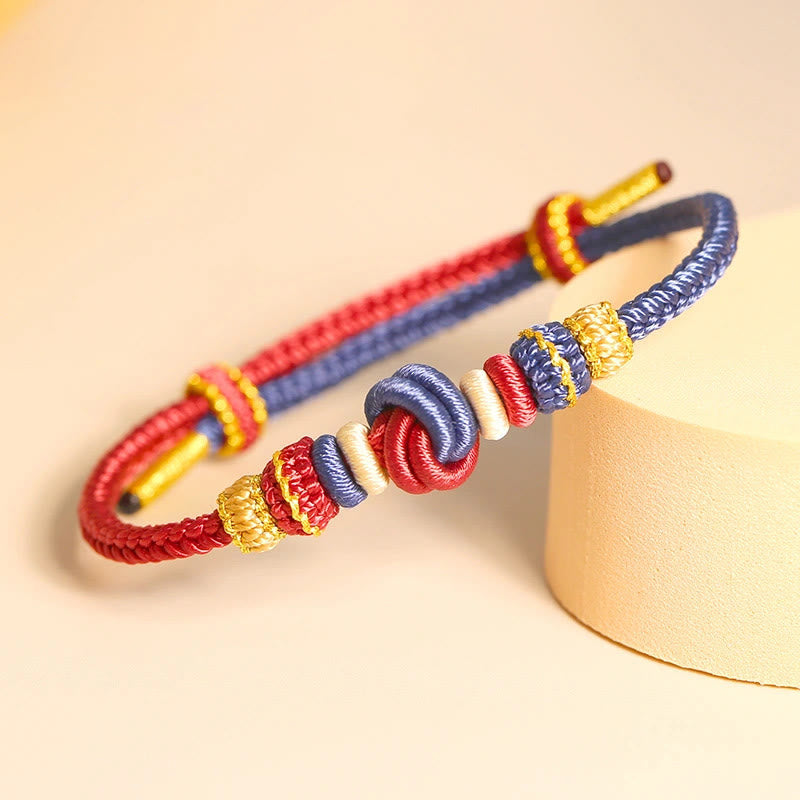 Handgefertigtes zweifarbiges Peace Knot-Armband aus roter Schnur