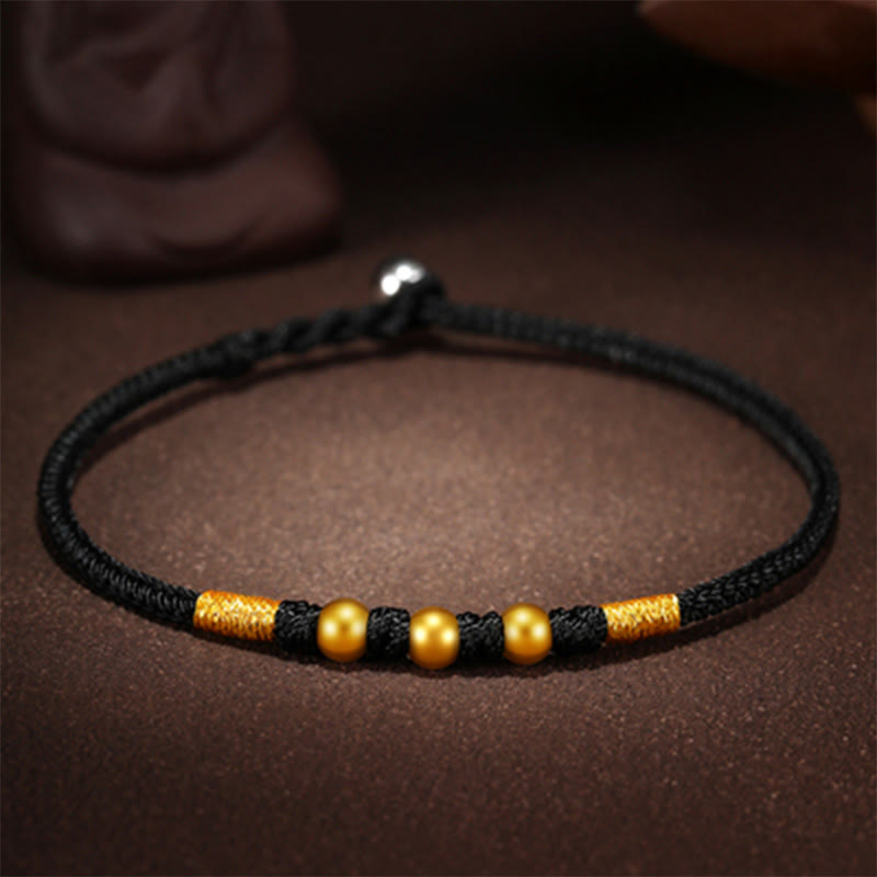 Handgefertigtes rotes Schnurarmband mit 999 Goldperlen und King Kong-Knoten zum Schutz