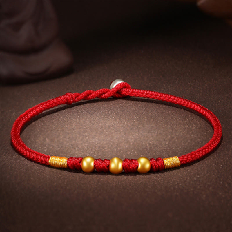 Handgefertigtes rotes Schnurarmband mit 999 Goldperlen und King Kong-Knoten zum Schutz