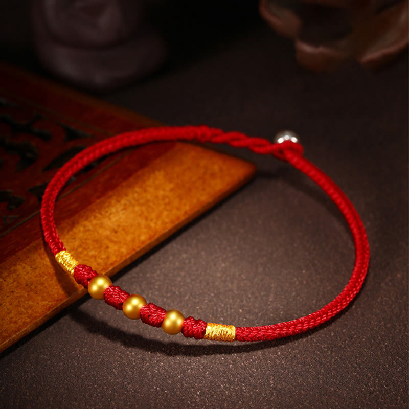 Handgefertigtes rotes Schnurarmband mit 999 Goldperlen und King Kong-Knoten zum Schutz