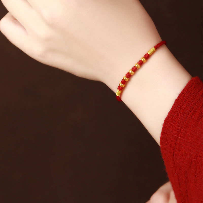 Handgefertigtes rotes Schnurarmband mit 999 Goldperlen und King Kong-Knoten zum Schutz