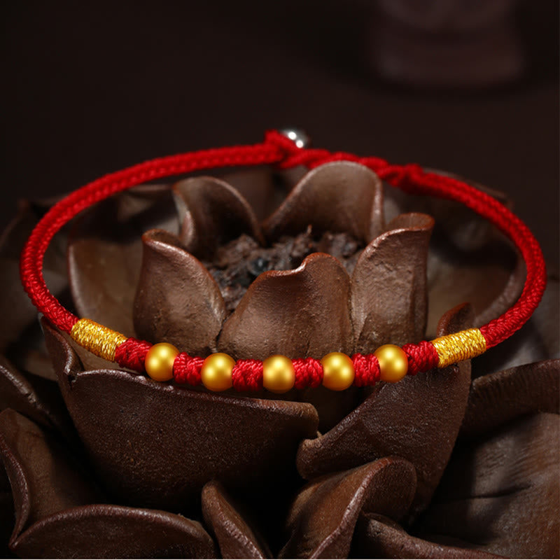 Handgefertigtes rotes Schnurarmband mit 999 Goldperlen und King Kong-Knoten zum Schutz