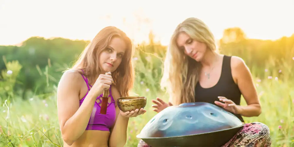 Blue and black handpan with a smooth, metallic surface.