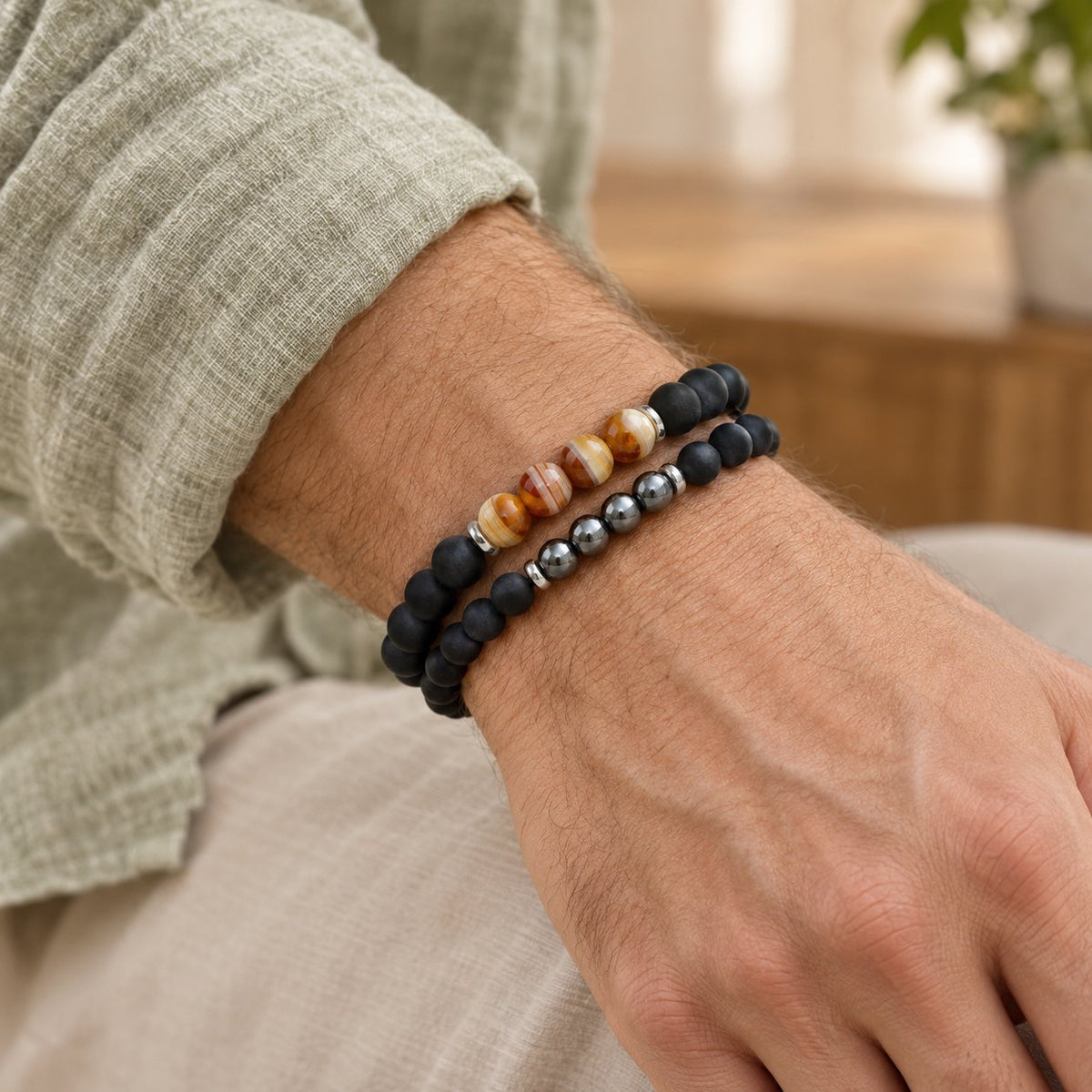 Hematite Agate Bracelet Set for Protection and Balance, worn on the wrist by a man