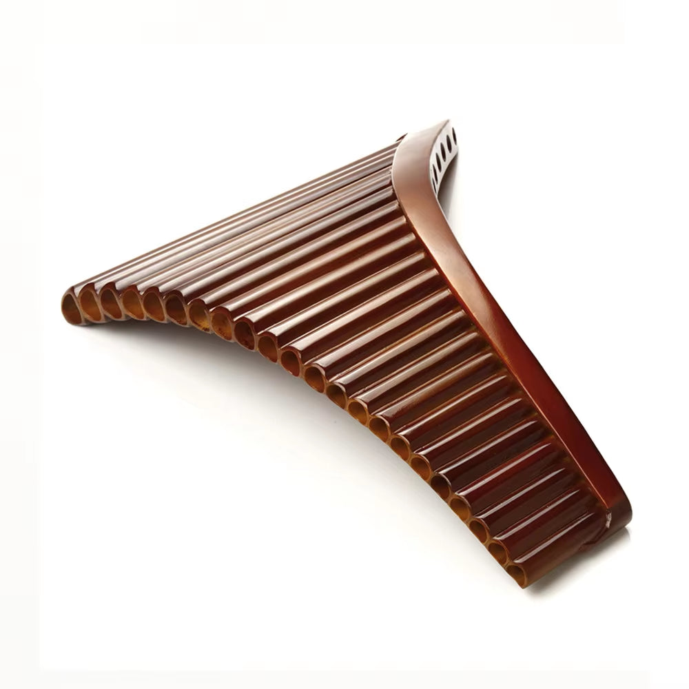 Brown plastic hair comb with curved ridges beside Natural Bamboo Pan Flute, 22 Pipes