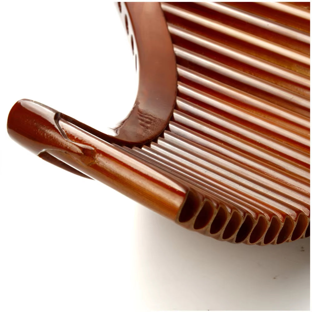 Brown plastic hair comb with curved ridges featured in Natural Bamboo Pan Flute product