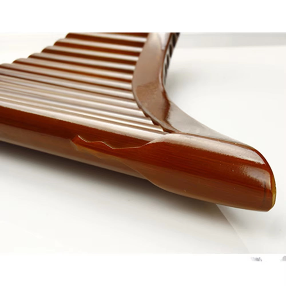 Milk chocolate bar with ridged surface beside Natural Bamboo Pan Flute in Key of G