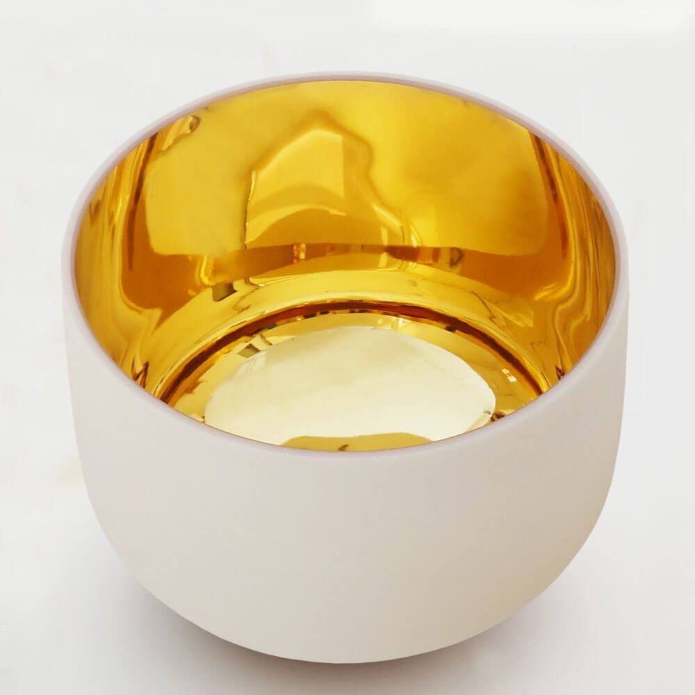 White ceramic bowl with a golden interior from the Perfect Pitch Alchemy Singing Bowl