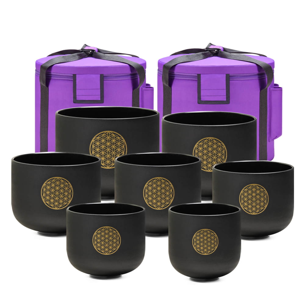 Set of black crystal singing bowls with gold Flower of Life symbols and purple cases