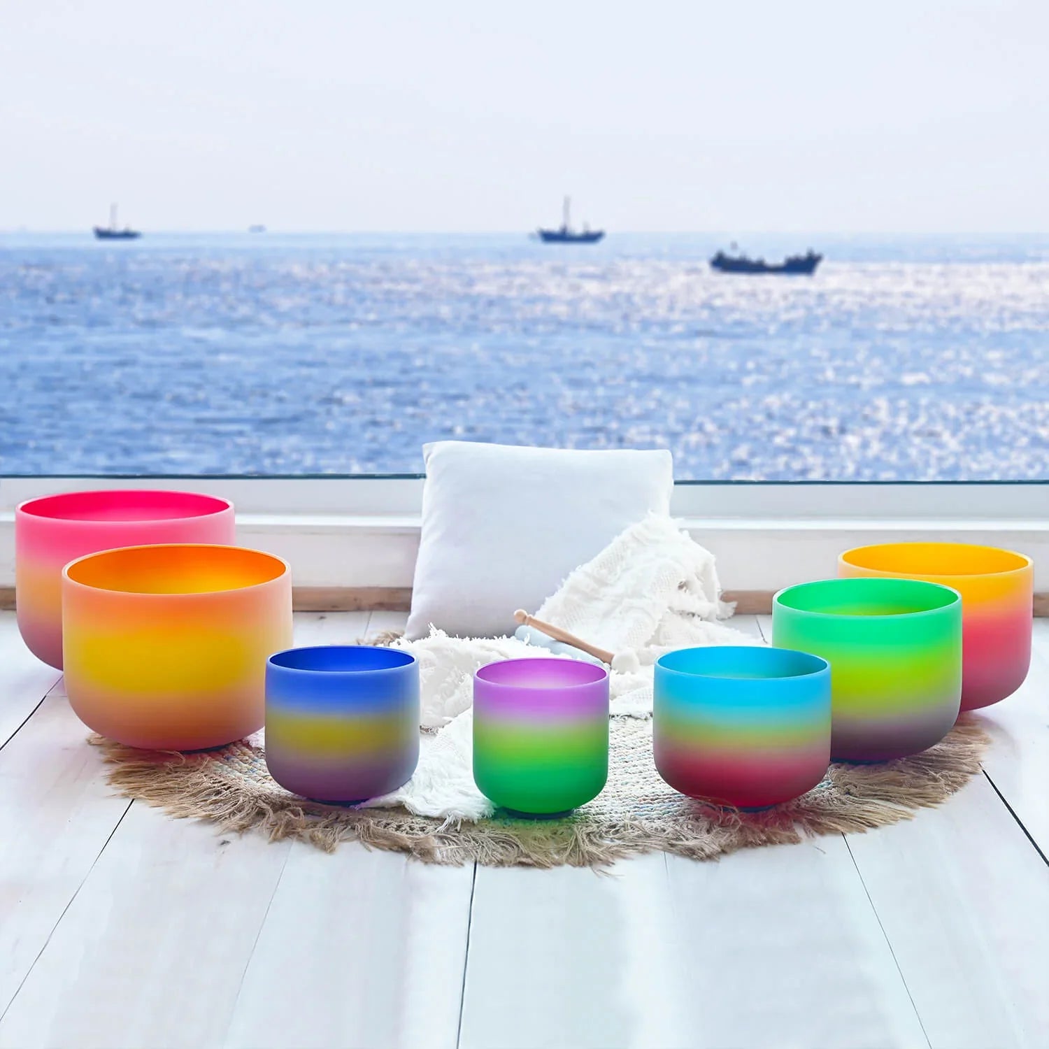 Colorful gradient crystal singing bowls arranged in semicircle for meditation set