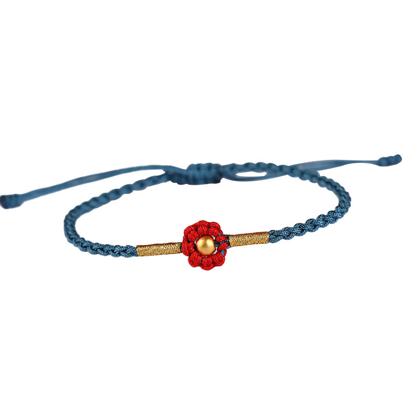 Rotes Schutzarmband mit goldener Blume