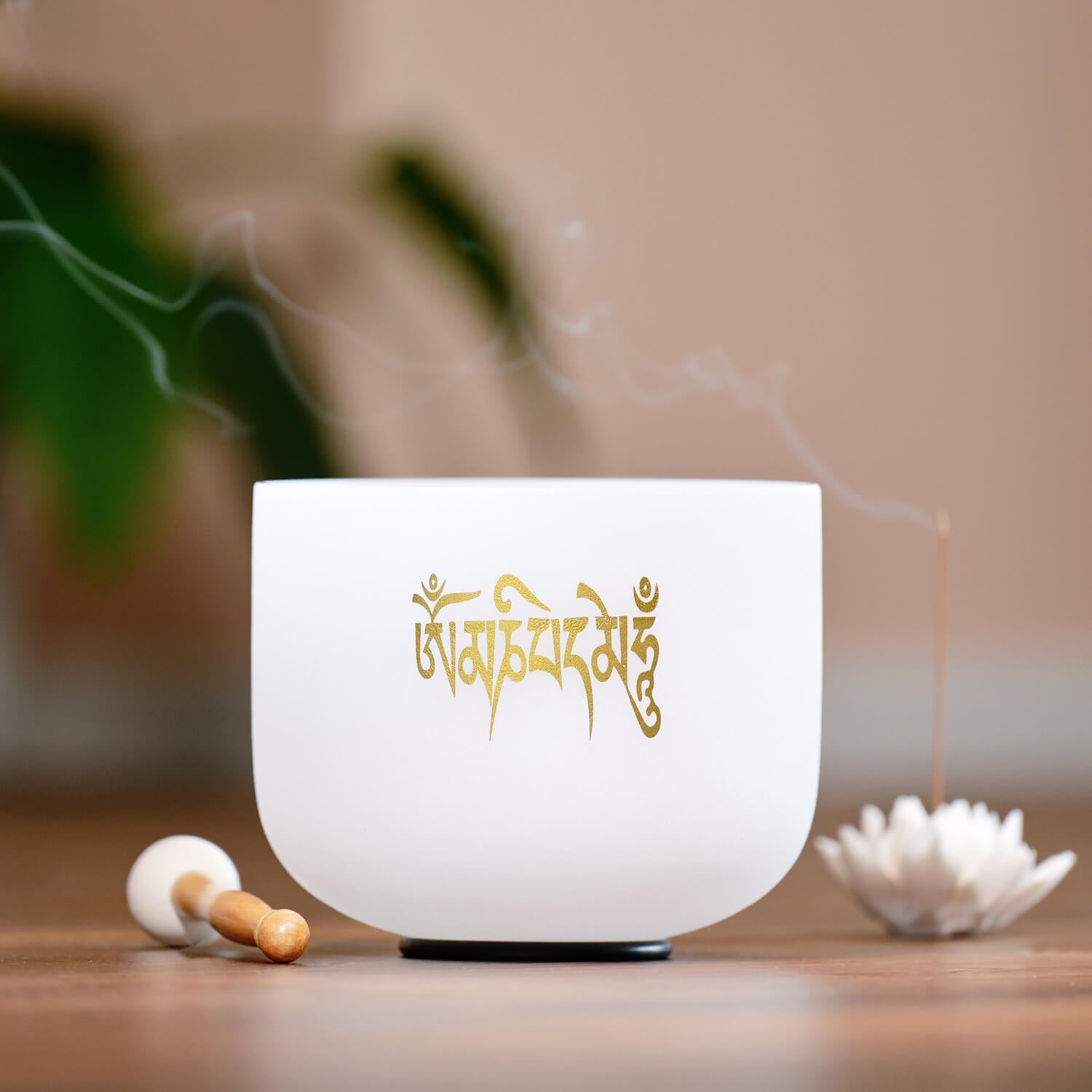 White crystal singing bowl with golden Sanskrit inscription for Six-Syllable Mantra