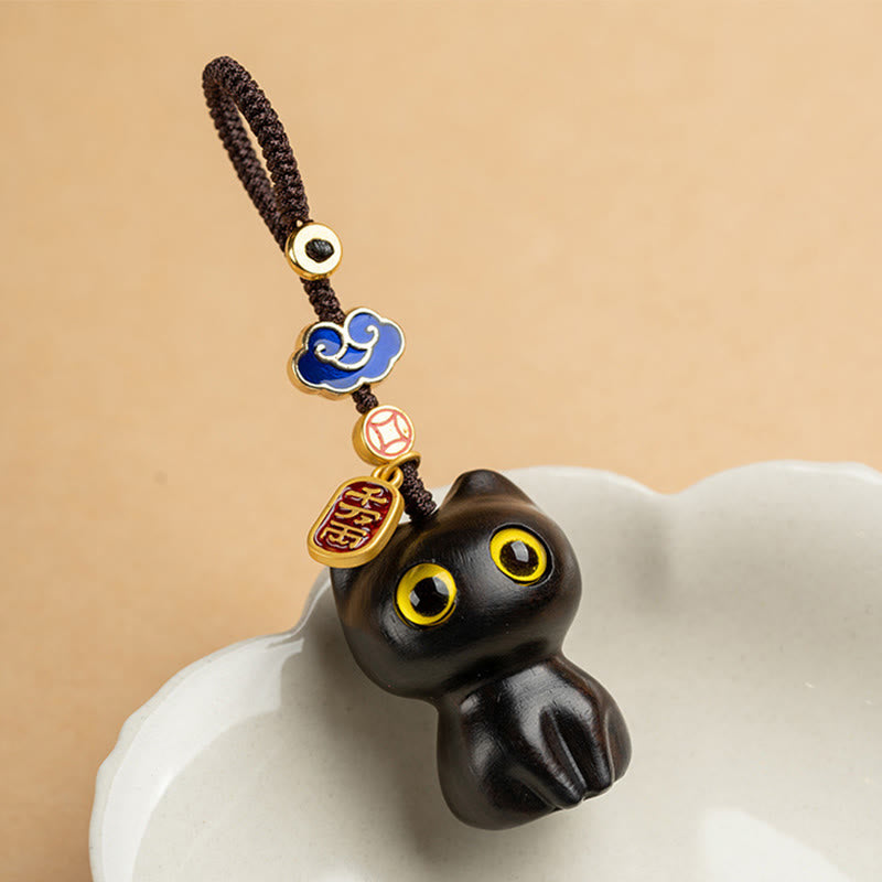 Kleiner Schutz-Schlüsselanhänger aus rotem Sandelholz und Ebenholz