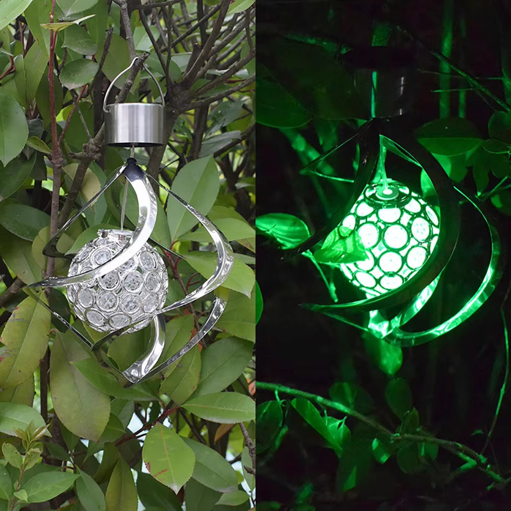 Solar-powered spiral wind spinner with green glowing orb for outdoor decor