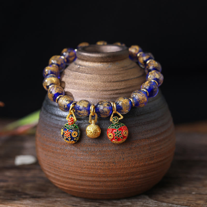Spirituelles Armband mit goldenem Schlucktier und Liuli-Perlen