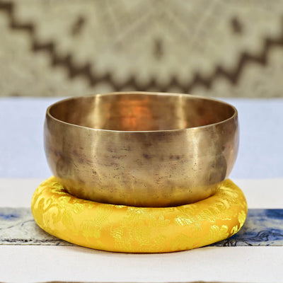 Brass Singing Bowl on Yellow Cushion for Tibetan Sound Bowl Meditation Healing