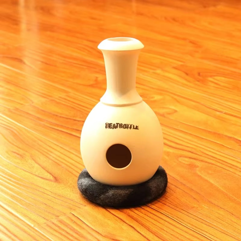 White ceramic Udu Drum with a circular hole and black base for African percussion