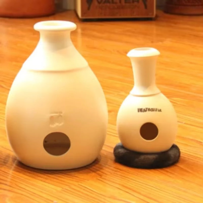 Two white ceramic vases with circular openings featured in Udu Drum African percussion drum